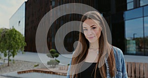 Close-up portrait of a happy young beautiful woman with long hair. Young woman looking into camera and smiling.