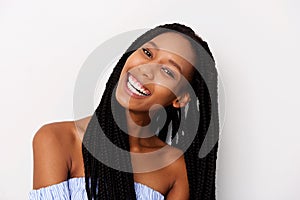 Close up portrait of happy young black woman with braided hair laughing