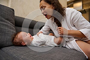 Close-up portrait of a happy young mother enjoying happy moments with her baby boy. Mom and kid face to face, together