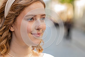 Close-up portrait of happy young satisfied woman face smiling friendly open eyes glad expression