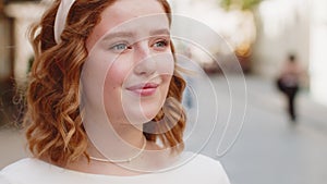 Close-up portrait of happy young satisfied woman face smiling friendly open eyes glad expression