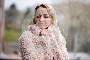 Close up portrait of a happy young woman with closed eyes