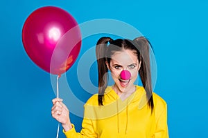 Close-up portrait of her she nice attractive funny sly cheerful cheery brown-haired girl clown holding in hand air ball