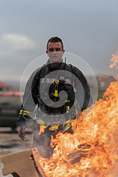 Close-up portrait of a heroic fireman in a protective suit. Firefighter in fire fighting operation.