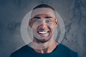 Close-up portrait of his he nice attractive cheerful cheery positive healthy guy wearing casual trendy blue t-shirt