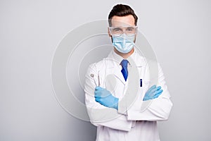 Close-up portrait of his he nice attractive cheerful experienced doc dentist holding in hands steel tools dental