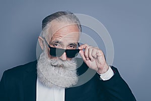 Close-up portrait of his he nice attractive chic classy brutal arrogant serious gray-haired man putting of specs looking