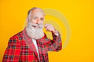 Close-up portrait of his he nice attractive handsome cheerful cheery content gray-haired man fixing mustache isolated