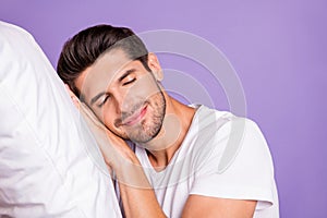 Close-up portrait of his he nice attractive sleepy brown-haired guy holding head on pillow drowsing fatigue bedtime