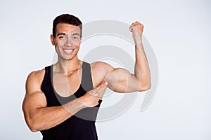 Close-up portrait of his he nice attractive sportive successful muscular cheerful cheery glad guy demonstrating powerful