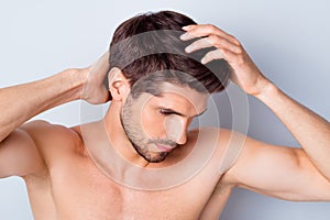 Close-up portrait of his he nice attractive stylish brown-haired guy touching smooth healthy shine hair anti dander