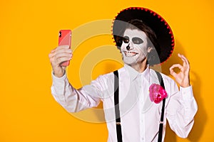 Close-up portrait of his he nice handsome cheerful glad spooky guy caballero making selfie calavera carnival celebration photo