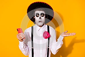 Close-up portrait of his he nice scary creepy spooky confused disappointed guy caballero using gadget shrugging photo