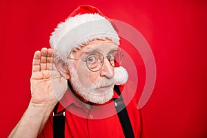 Close-up portrait of his he nice serious suspicious bearded Santa Claus trying to overhear what you say speak tell