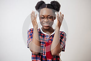 Close up portrait of laughing Afro woman with raised arms