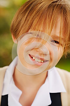 Portrait of lilt blonde teenage girl with short haircut in school uniform. photo