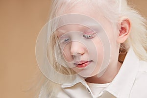 Close-up portrait of little albino girl