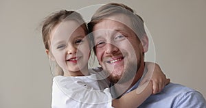 Close up portrait little girl cuddles her loving dad