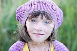 Close-up portrait of little girl in violet beret