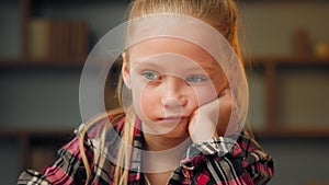 Close up portrait little offended child sad upset bored preschool girl pretty blonde female kid look at camera sit at