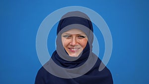 Close up portrait of lovely young muslim business woman wearing hijab headscarf looking confident smiling calm