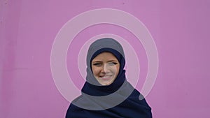 Close up portrait of lovely young muslim business woman wearing hijab headscarf looking confident smiling calm