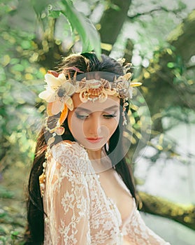 Close-up portrait - makeup of a river nymph, in gentle green, yellow, peach hues. The brunette girl with an unusual