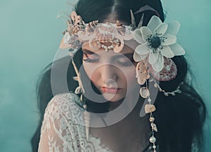 Close-up portrait - makeup of a river nymph, in gentle green, yellow, peach hues. The brunette girl with an unusual