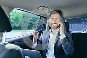 Close-up portrait of a man, a car passenger talking on the phone and looking out the open window