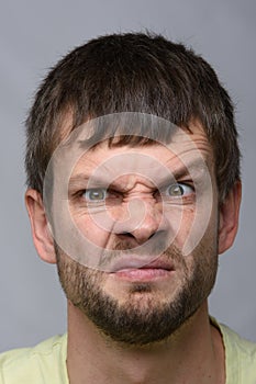 Close-up portrait of a man funny frowning eyebrow of European appearance