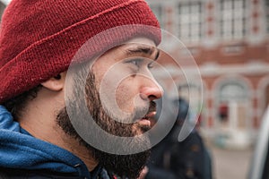 Close-Up Portrait of a Man in Red Beanie in Dinant, Belgium