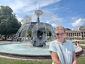 Close up portrait mature woman at the Schlossplatz Fountain in Stuttgart