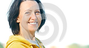 Close up portrait of mature woman weared in sports clothes in the park