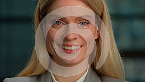 Close Up Portrait of Middle-aged Caucasian lady Adult Woman Posing for Camera in Creative Office Smile Toothy. Cheerful