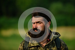 Close up portrait of middle aged farmer bearded man, outdoors in countryside meadow. Man portrait on farmland.