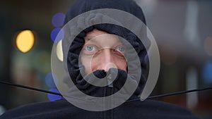 Close-up portrait of a middle-aged man in a tightened hood