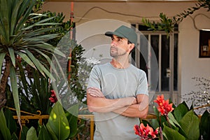 Close-up portrait Middle-aged man working at the house, Gardener near Calathea Lutea Plant