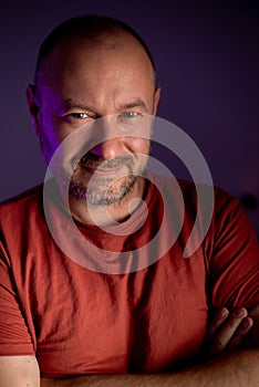 Close-up portrait of a middle-aged, unshaven man with an approachable expression, wearing an ordinary look, and sporting