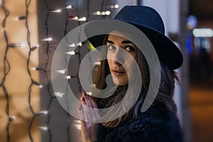 Close-up portrait of model woman with dark hat