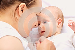 Close-up portrait. Mother and baby face-to-face.