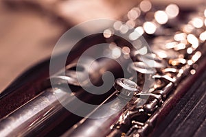 A close up portrait of a music case with a disassembled metal silver flute in it with valves to play notes. the musical instrument