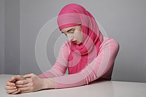 Close-up portrait of a muslim woman wearing a head scarf hijab and smilling. Isolated.