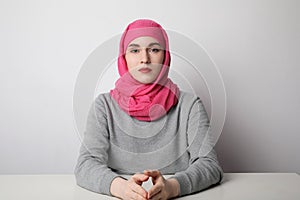 Close-up portrait of a muslim woman wearing a head scarf and smilling. Isolated.