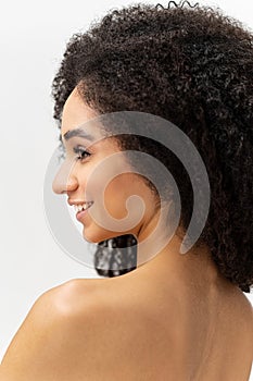 Close-up portrait of naked lady looking aside and smiling dreamy. Well-looking serene brunette woman with smooth pure