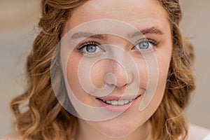 Close-up portrait natural beauty young beautiful redhead woman girl face smiling looking at camera
