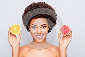 Close-up portrait of nice attractive cheerful cheery shine wavy-haired girl holding in hand grapefruit orange pieces