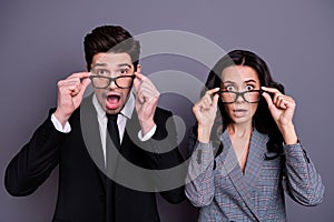 Close-up portrait of nice attractive stylish smart clever intelligent terrified partners finance experts touching specs