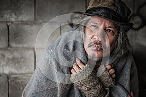 Close up and portrait of old homeless asian man gray hair and beard