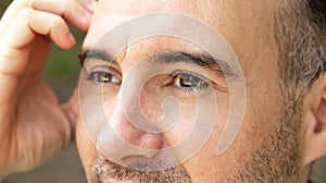 close up portrait of pensive man scratching his head