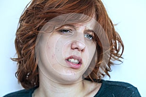 close-up portrait of a pensive teenage girl with red hair .